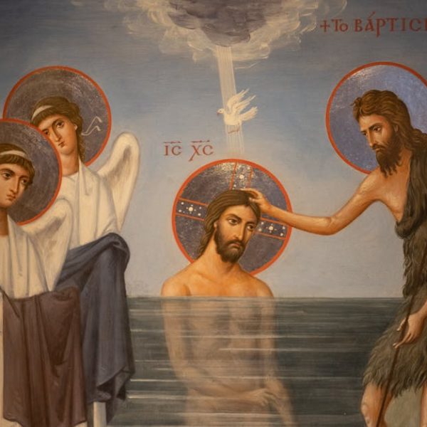 Religious painting showing Jesus being baptized in a river by John the Baptist, with two angels standing nearby and a dove above.